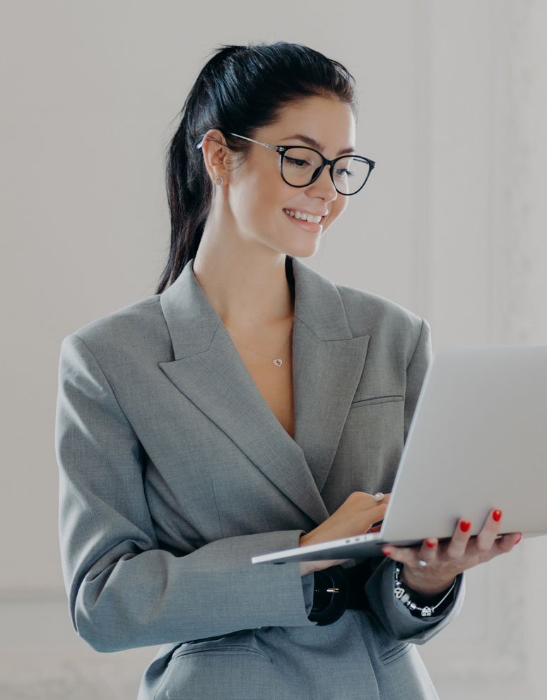happy-female-entrepreneur-types-on-laptop-computer-WWAFEMW.jpg